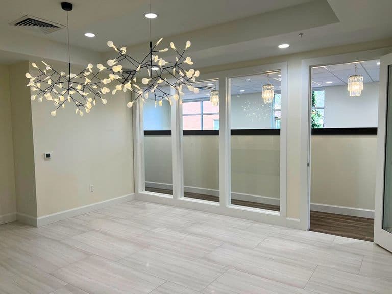 Glass walled private office with modern chandelier at 1045 East 3900 South in Millcreek