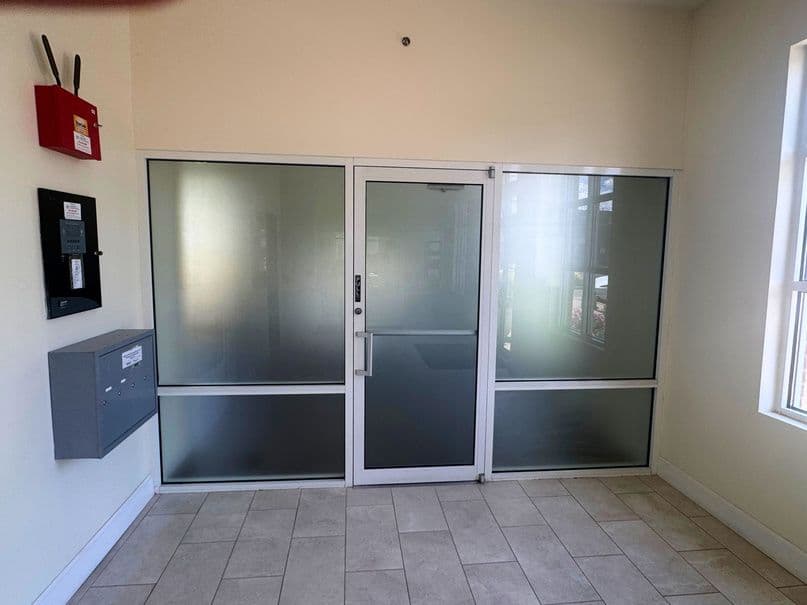 Entry with frosted glass double doors and tile floor at 1045 East 3900 South in Millcreek