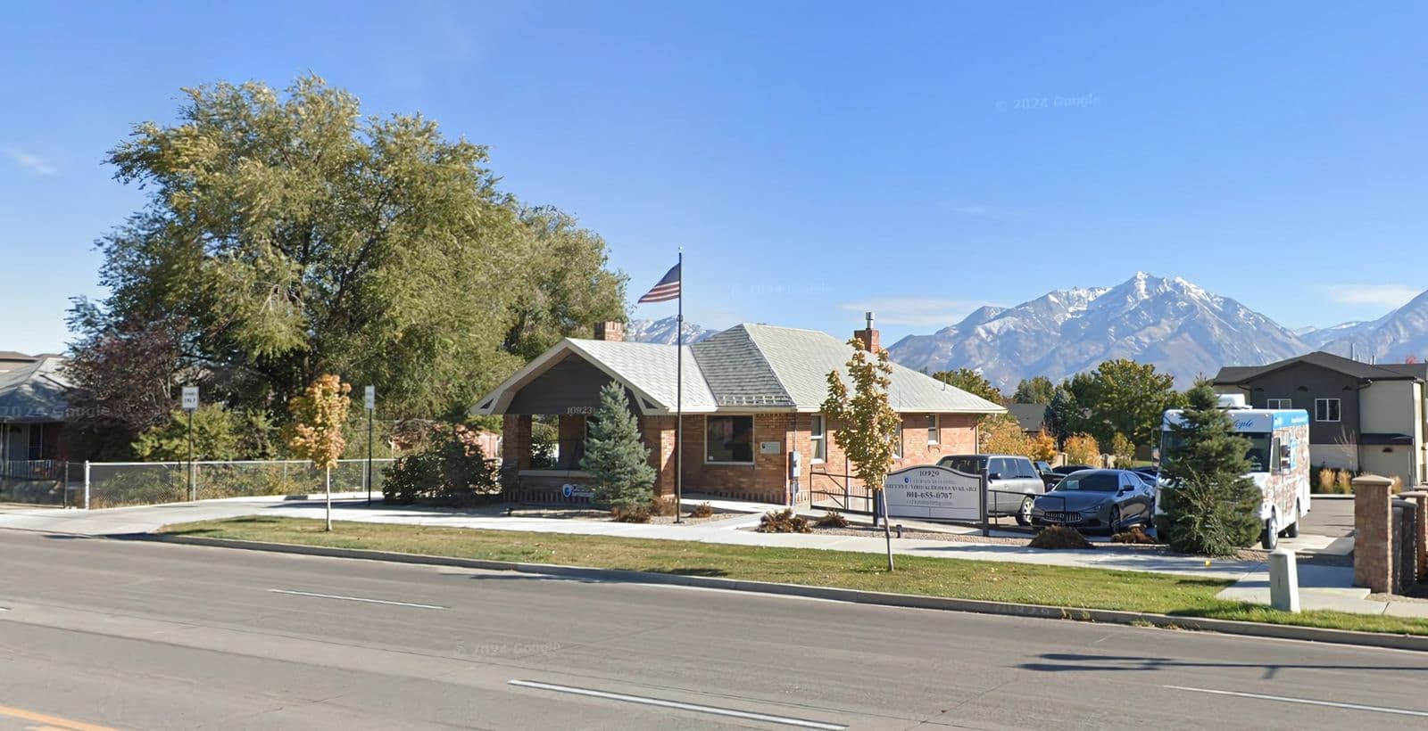 Street view of the office bungalow and grounds at 10923 South Redwood Road in South Jordan