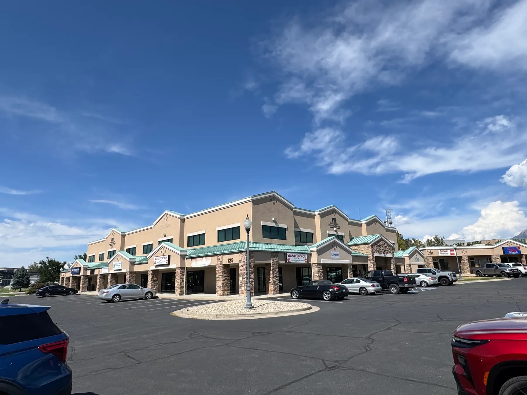 Parking field in front of the 129 S State St storefronts, Clearfield Town Square