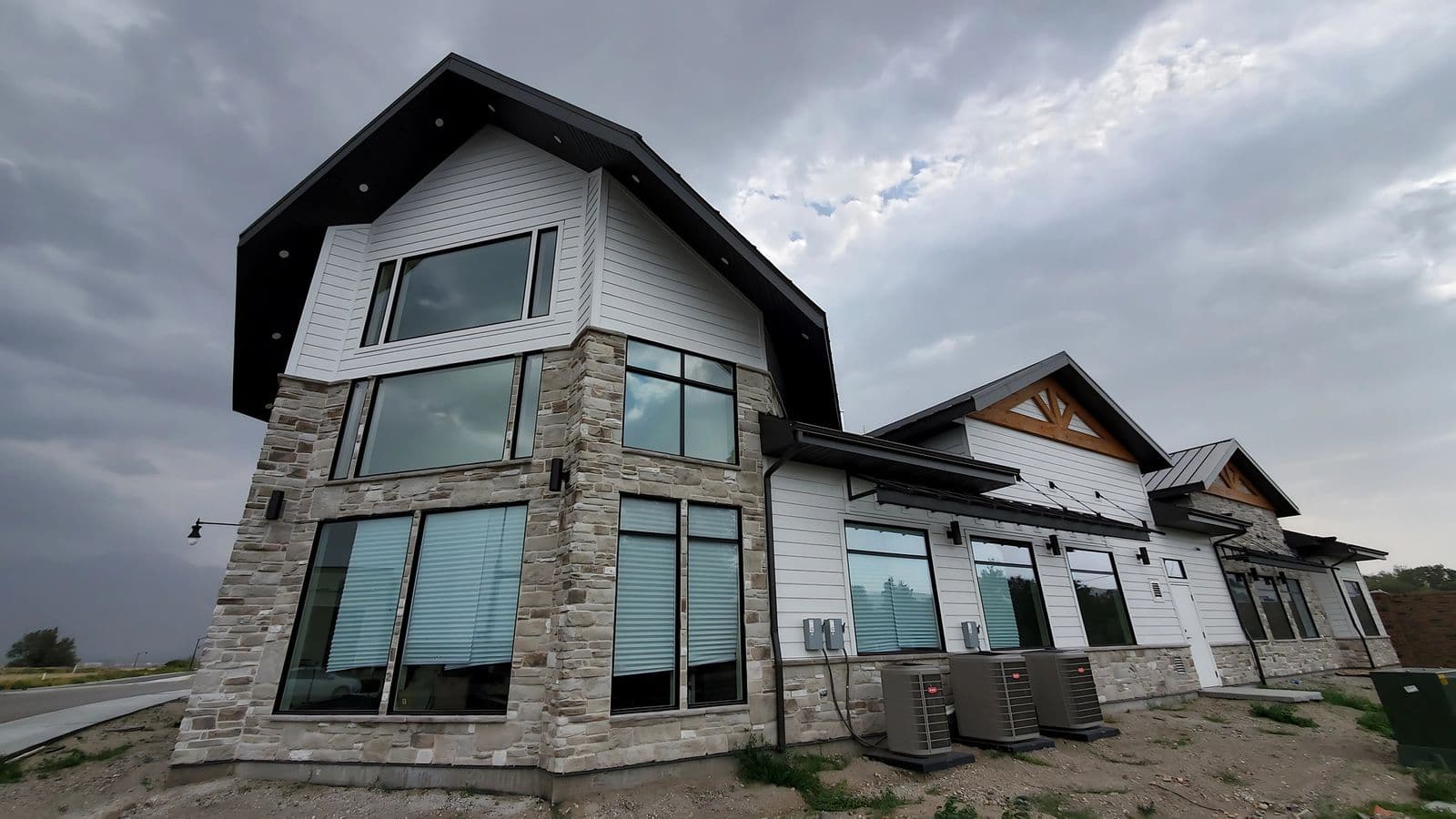 Corner view of the stone and timber retail building at 14003 South Redwood Road in Bluffdale