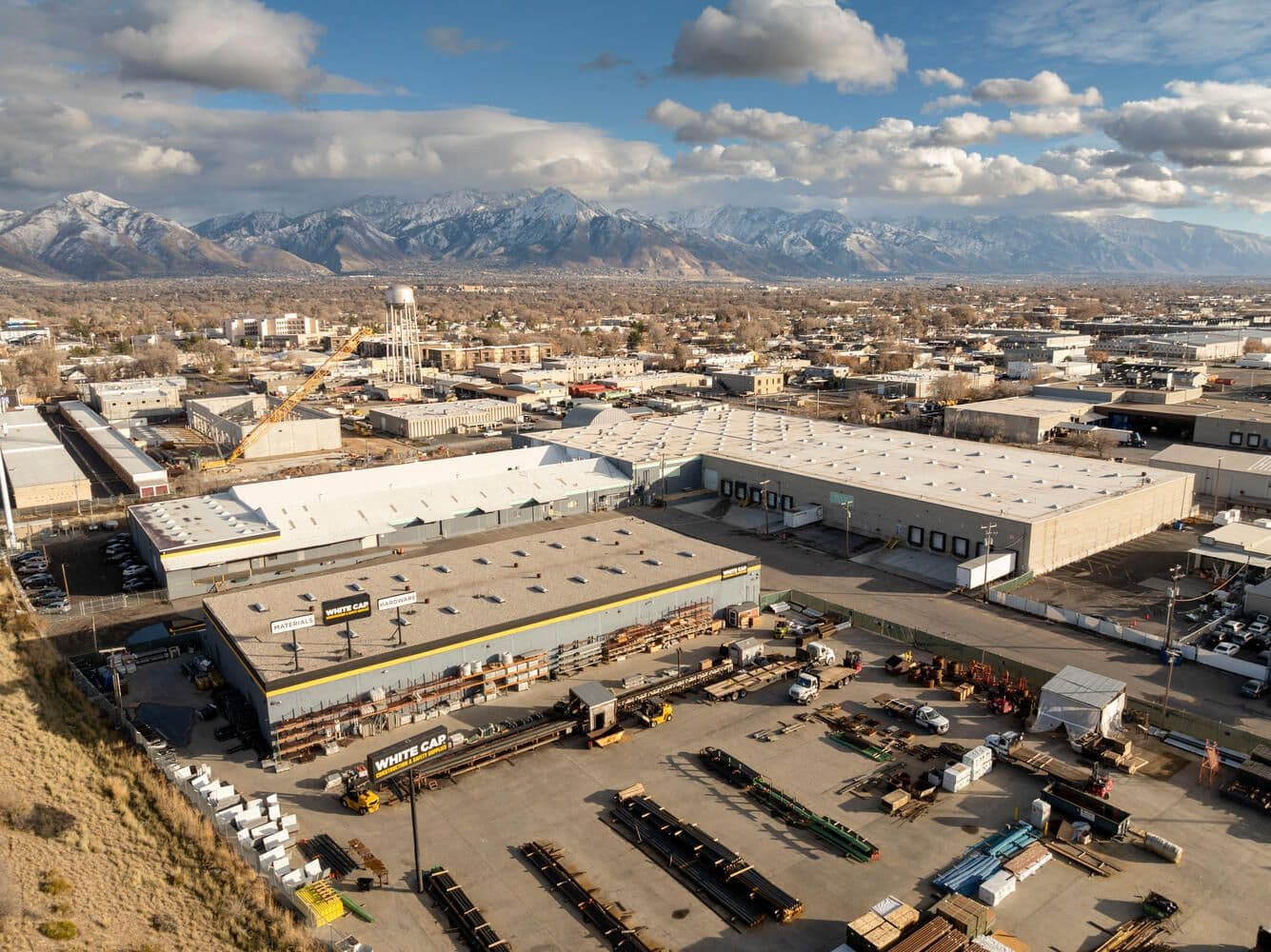 Aerial of the warehouse at 2507 South 300 West with the Salt Lake skyline behind