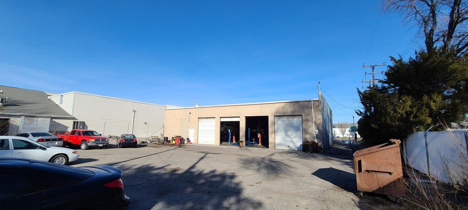 Fenced yard and rear service bay doors at 3385 West 3500 South in West Valley City
