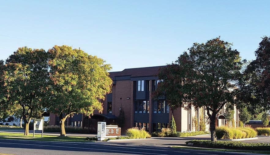Brick office building among mature trees at 3920 South 1100 East in Millcreek