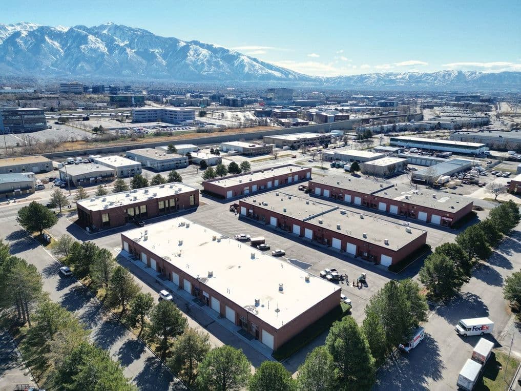 Aerial of Sandy Industrial Park at 9460-9548 South 500 West with the Wasatch behind